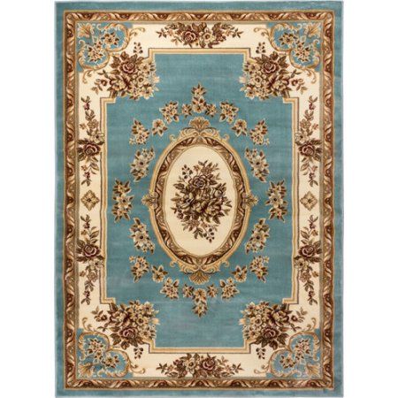 a blue rug with gold trimmings and an ornate design on the center piece