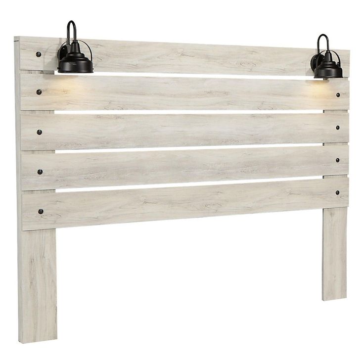 a white wooden headboard with two lights on each side and one light at the top