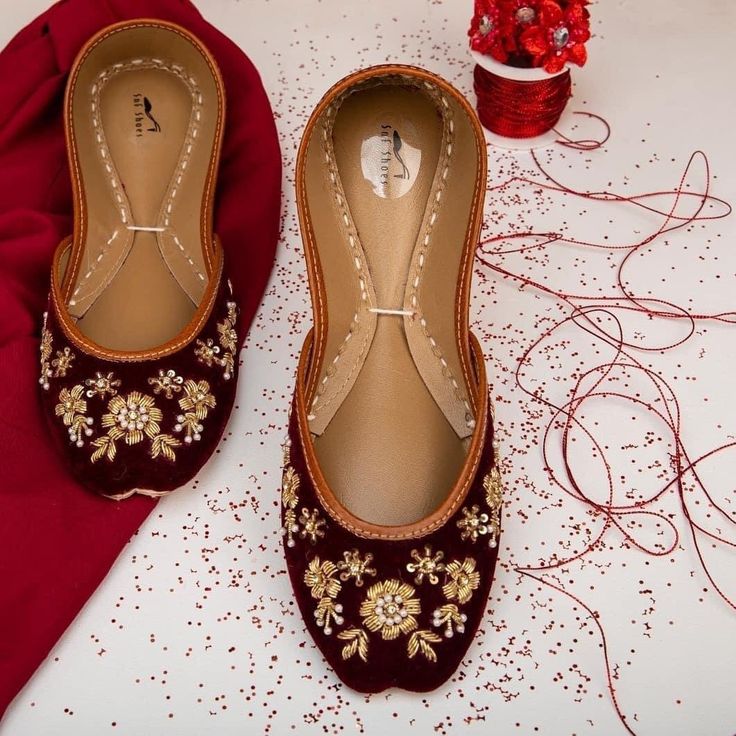 "* Maroon base with copper embellishements on flat shoes. * Easy and comfortable to wear. * Perfect for every occasion. * Best in quality. * Handmade by me. Please chose your size from the below chat. If you are not sure about your size, please let us know.We ll help you out. Sizes: *EUR36-UK3-US5-PAKISTAN 6-INCHES-8.5\"-CM 21.25 *EUR37-UK4-US6-PAKISTAN 7-INCHES-9\"-CM 22.50 *EUR38-UK5-US7-PAKISTAN 8-INCHES-9.5\"-CM 23.75 *EUR39-UK6-US8-PAKISTAN 9-INCHES-10\"-CM 25 *EUR40-UK7-US9-PAKISTAN 10-INC Festive Flats With Dori Work, Festive Ankle-length Flats With Dori Work, Embroidered Flat Heel Wedding Shoes, Bollywood Style Wedding Shoes For Festive Occasion, Red Round Toe Flats For Wedding, Festive Embroidered Party Flats, Bollywood Style Wedding Shoes With Zari Work For Reception, Zari Work Wedding Shoes For Festivals, Festive Zari Work Wedding Shoes