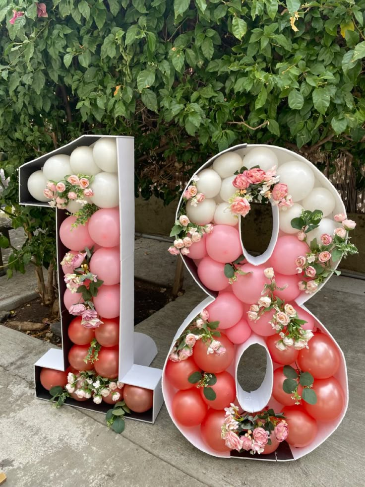 a large number made out of balloons and flowers