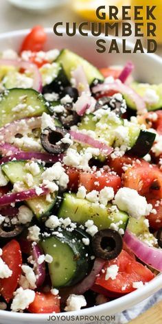 greek cucumber salad with feta cheese and olives in a white bowl