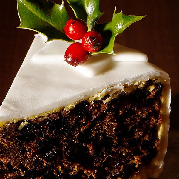 a piece of cake with frosting and holly on top