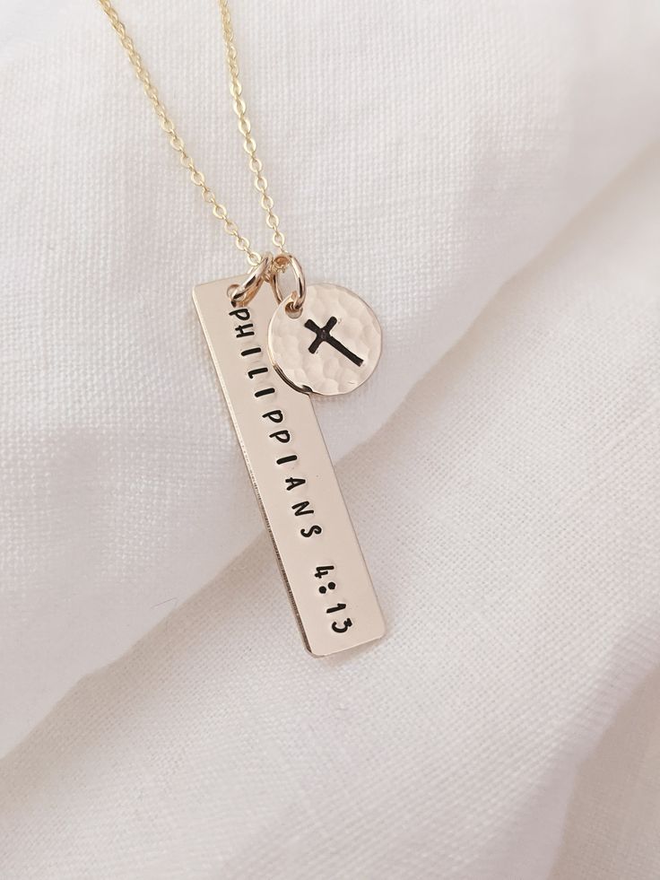 "Philippians 4:13 necklace, 14k Gold Fill or Sterling Silver, Bible verse necklace, Christian necklace, Cross necklace, Religious jewelry, Motivational gift, Gift for her, Faith necklace, Faith can move mountains, Baptism necklace D E T A I L S * Gold Filled: Gold Filled Disc, Clasp and Chain. * Sterling: .925 Sterling Silver Disc, Clasp and Chain. P E N D A N T S * 3/8\" hammered disc * 1.25\" x .25\" polished bar * Shown with a Polished Finish. * All personalization is done by hand. ♡ Comes as Cross Necklace Message Card, Cute Christian Necklaces, Gold Christian Jewelry, Cute Christian Jewelry, Christian Necklace For Women, Christian Business Ideas Products, Mrs Jewelry, Christian Gifts For Him, Bible Necklace