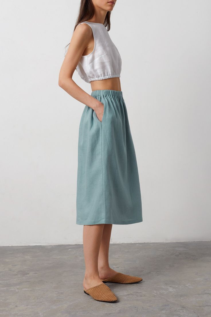 "ELLE is a casual linen midi skirt. DETAILS - Midi length - Elastic waist - 100% lightweight European linen fabric - Cut and sewn to order just for you in our studio COLOR - Dark Turqouise, you can also choose other colors above SIZING & FIT - Fits true to size - Model is 5'9.5\" / 177cm, wearing a size XS CARE FOR LINEN - Machine wash up to 30ºC/86ºF gentle cycle - Lay flat to dry or tumble dry low - Warm iron if needed - Do not bleach SIZE GUIDE Size conversion guide Size XS (US 0-2, IT 36-38, UK 4-6, Japan 3-5, France 32-34) Size S (US 4-6, IT 40-42, UK 8-10, Japan 7-9, France 36-38) Size M (US 8-10, IT 44-46, UK 12-14, Japan 11-13, France 40-42) Size L (US 12-14, IT 48-50, UK 16-18, Japan 15-17, France 44-46) Size XL (US 16-18, IT 52, UK 20-22, Japan 19, France 48) Body measurements gu Cotton Midi Skirt Outfit Summer, Casual Linen Midi Skirt, Casual Linen Midi Bottoms, Linen Skirt With Elastic Waistband For Day Out, Summer Linen Midi-length Bottoms, Spring Linen Midi Skirt, Spring Midi-length Linen Skirt, Spring Midi Length Linen Skirt, Summer Linen Skirt With Elastic Waistband