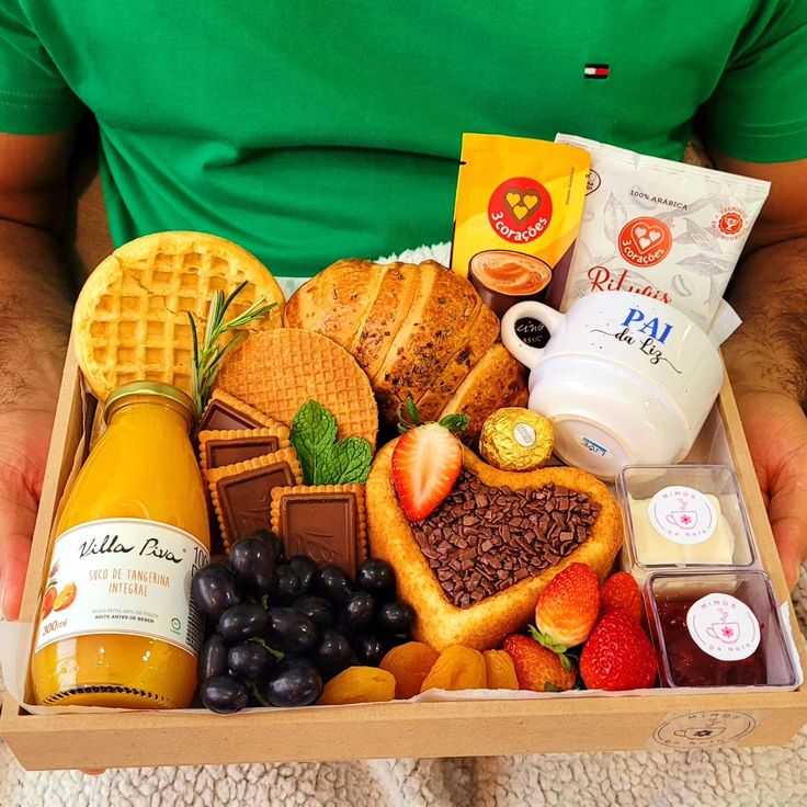 a man holding a box full of food and drinks