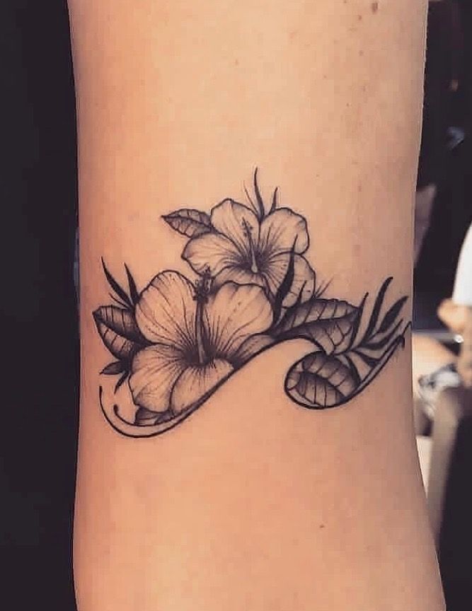 a woman's arm with flowers on it