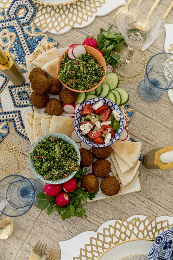 the table is set with plates, bowls and utensils for an appetizer