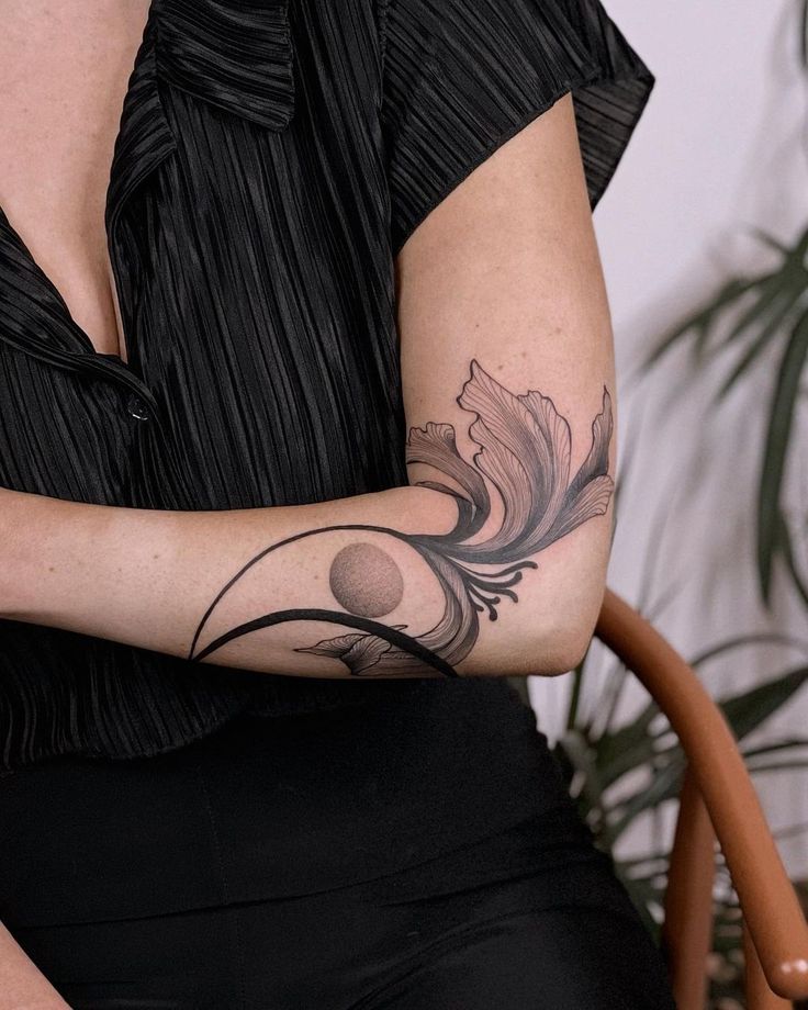 a woman with a tattoo on her arm