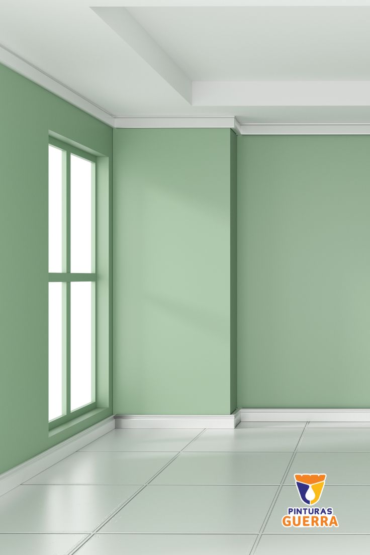 an empty room with green walls and white floors