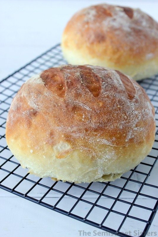 two loaves of bread sitting on top of a cooling rack