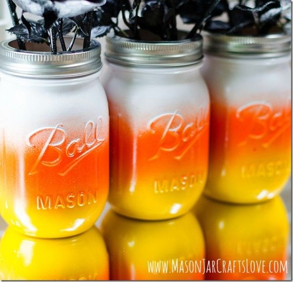 three mason jars with flowers in them sitting next to each other