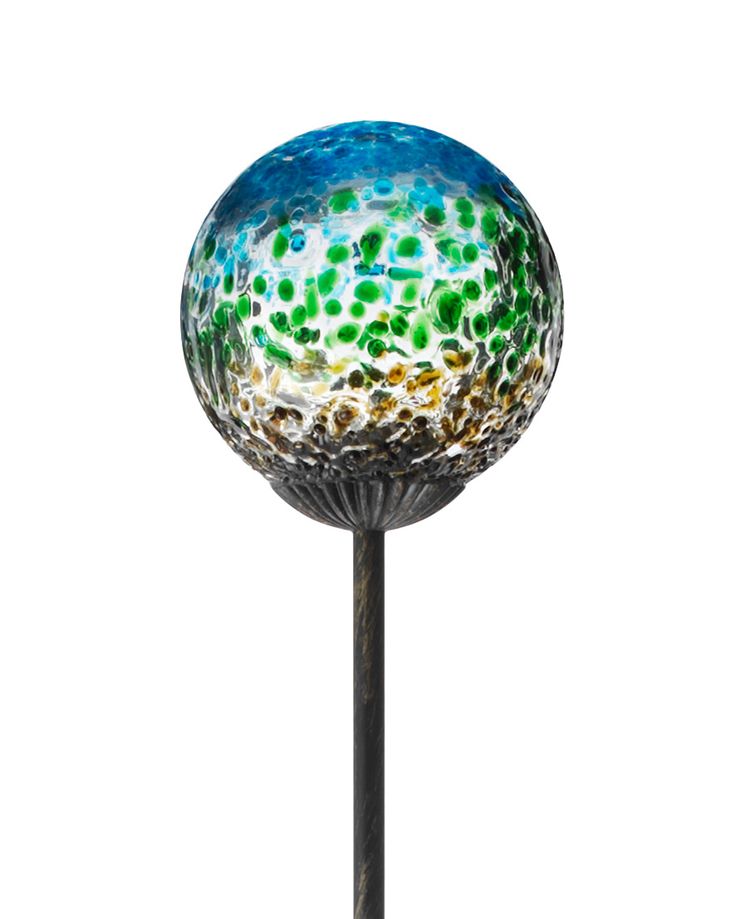 a glass ball sitting on top of a metal pole in front of a white background