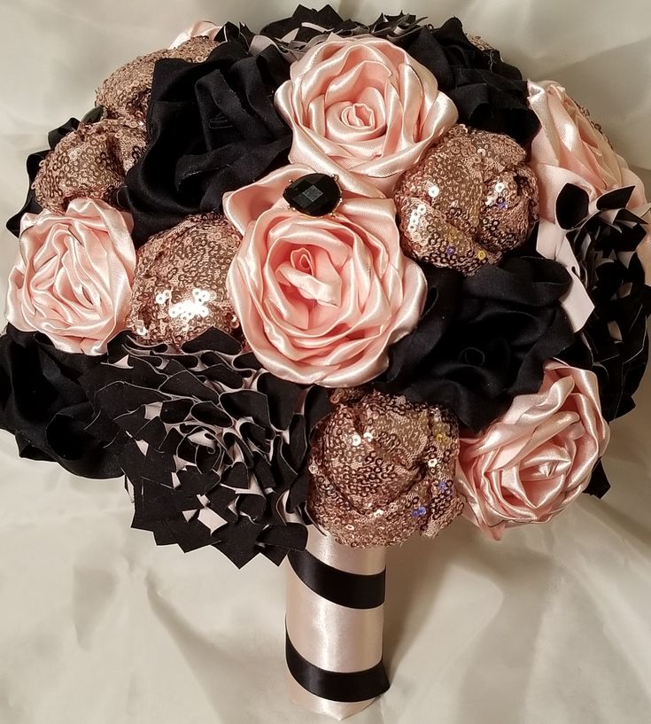 a bridal bouquet with black and pink flowers