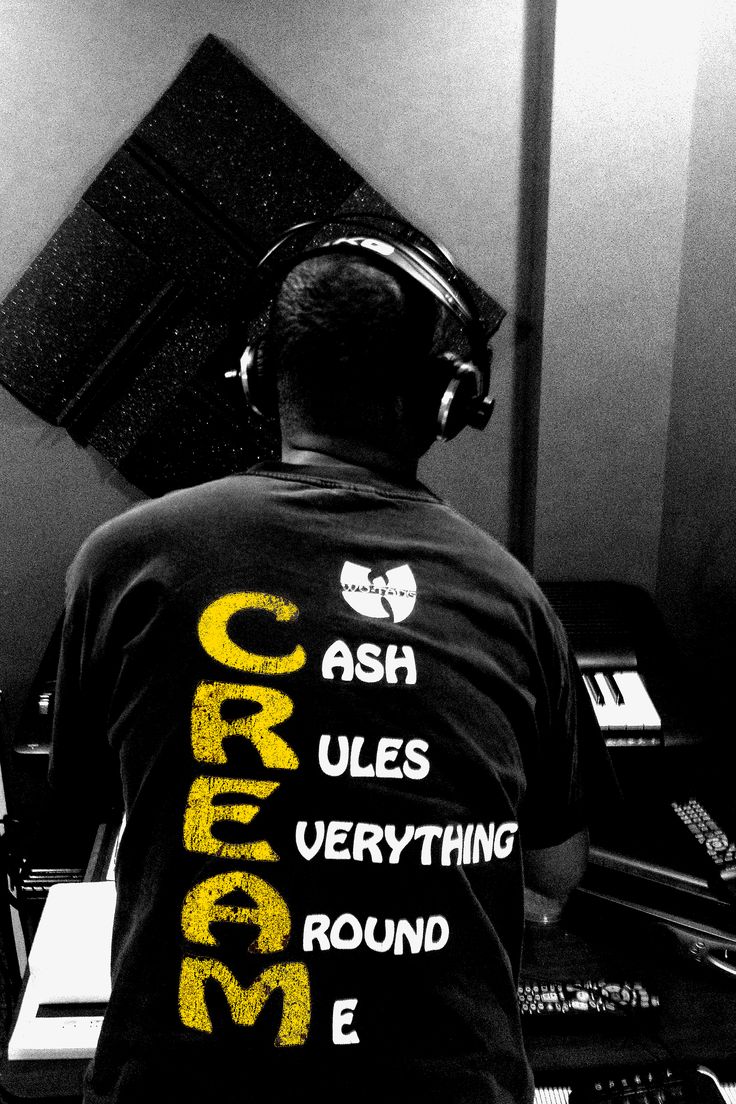 a man wearing headphones sitting in front of a computer desk with sound equipment on it