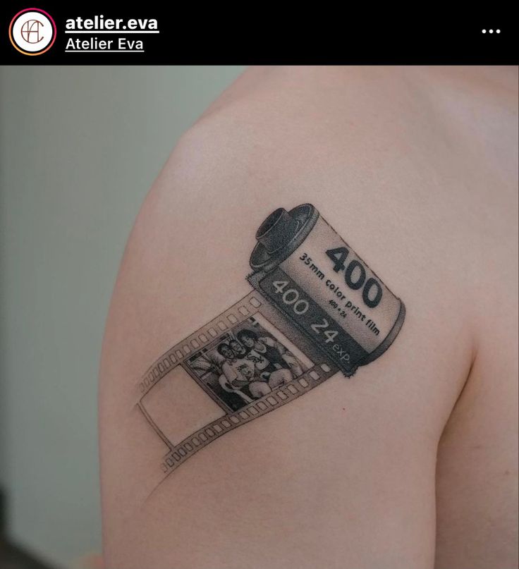 a man with a tattoo on his arm holding a can of film and some money