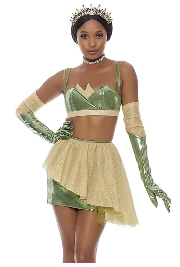 a woman in a green and gold costume is posing for the camera with her hands on her hips