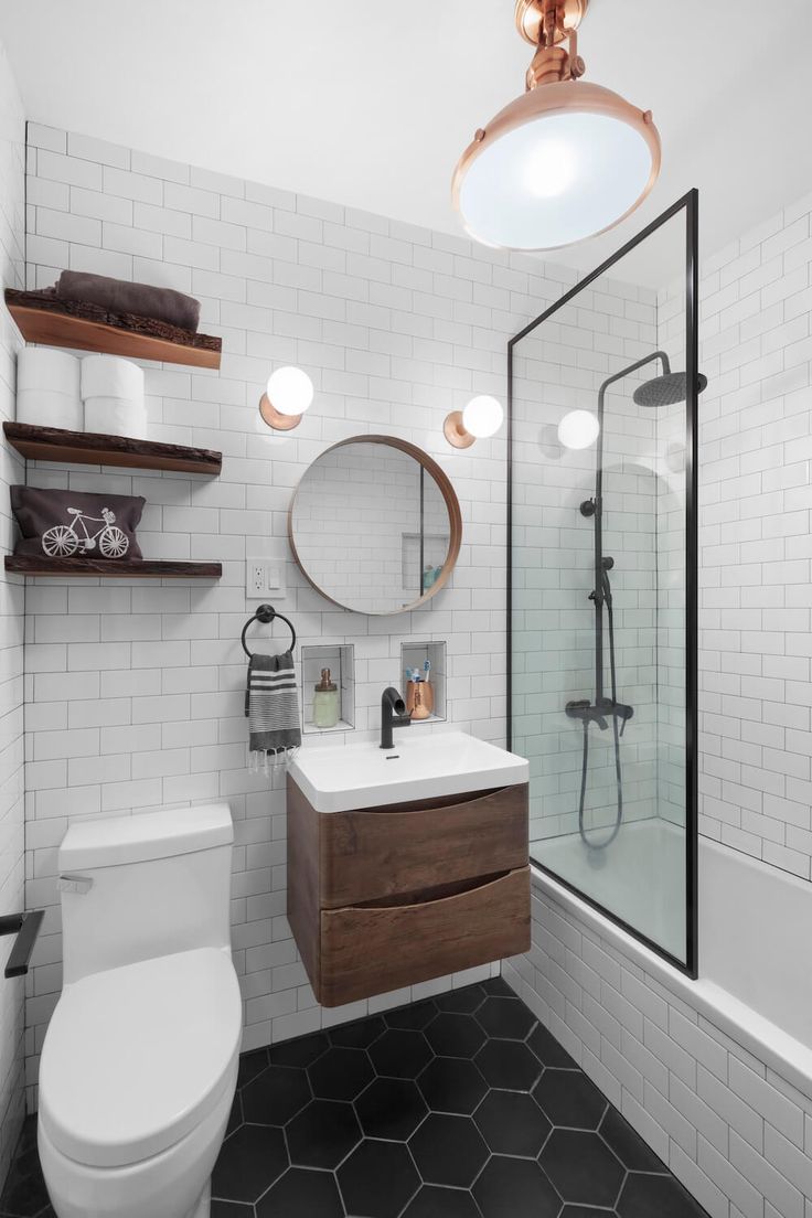 a bathroom with black and white flooring and hexagonal tiles on the walls