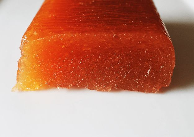 an orange piece of food sitting on top of a white table