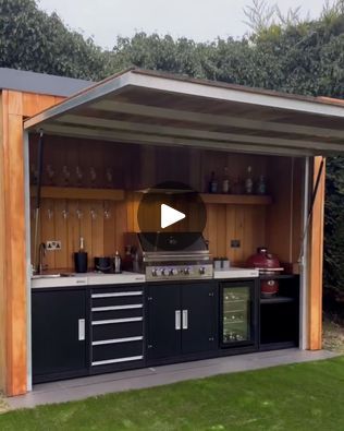 an outdoor kitchen is built into the side of a shed with lots of storage space