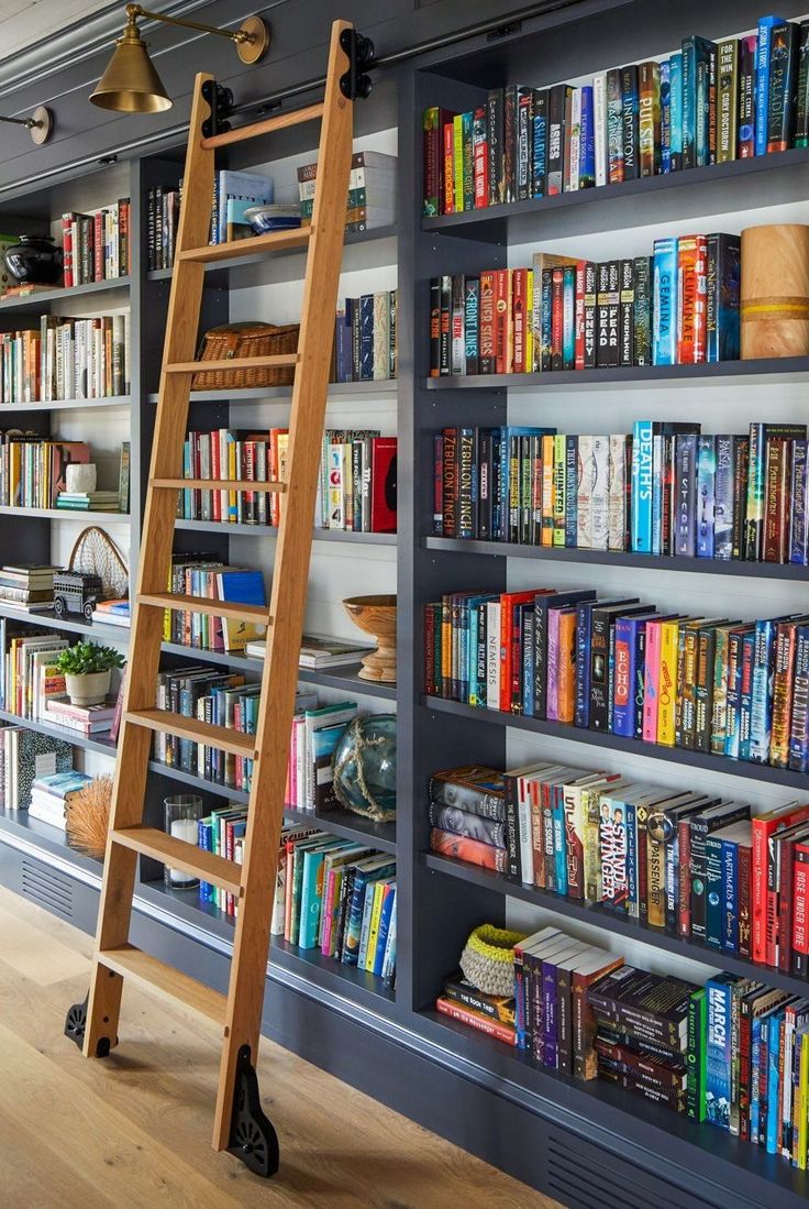 These cozy spaces are a book-lover's dream. How To Build A Home Library, Small Library In House, Wall Library Ideas, Small House Library Ideas, Home Library Ladder, Farmhouse Library Room, Rolling Ladder Bookshelf, Library Wall With Ladder, Library With Rolling Ladder