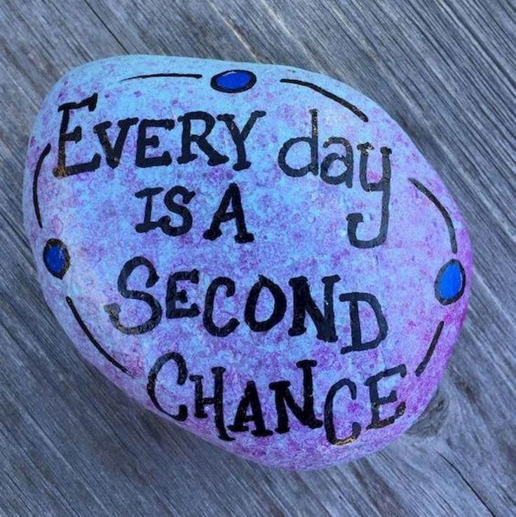 a painted rock with the words every day is a second chance written in black on it