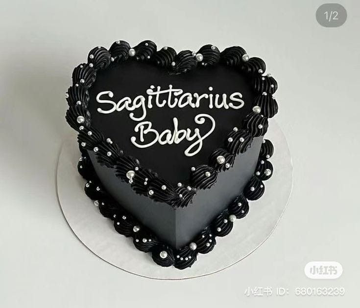 a heart shaped cake with the words sagittarius baby written on it