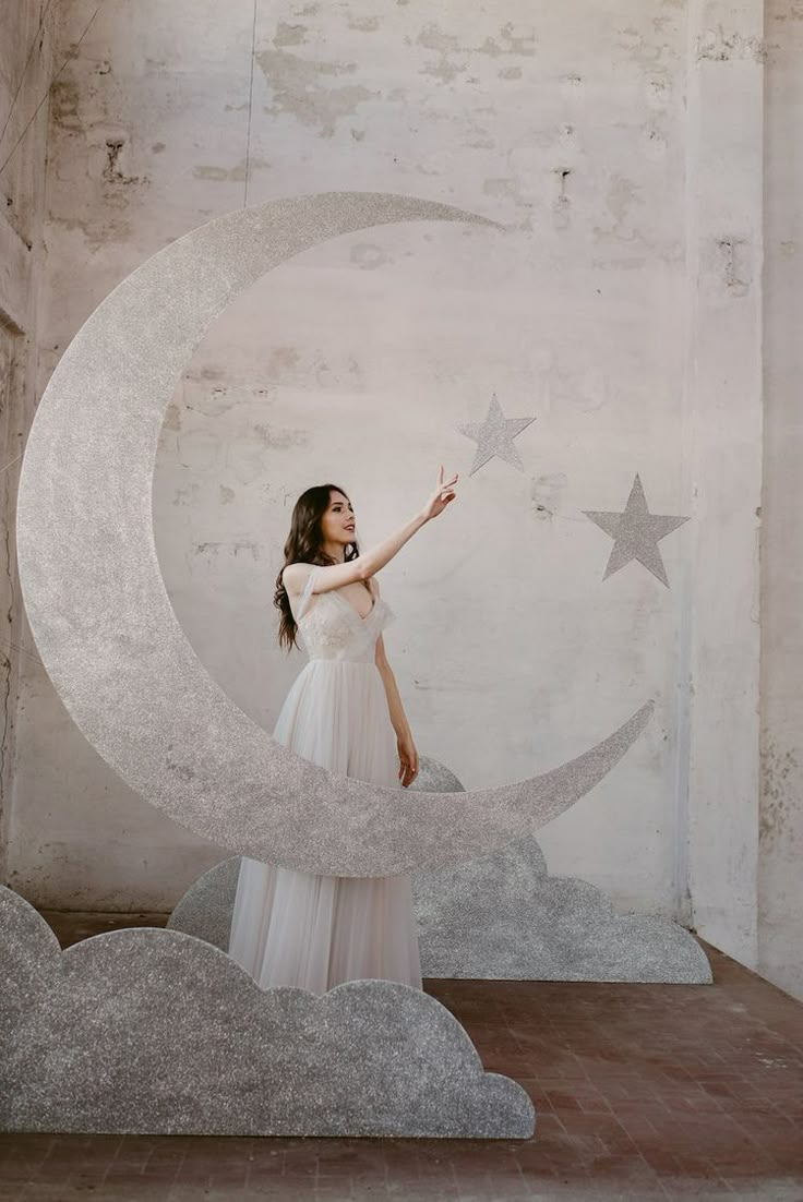 a woman standing in front of a moon and stars