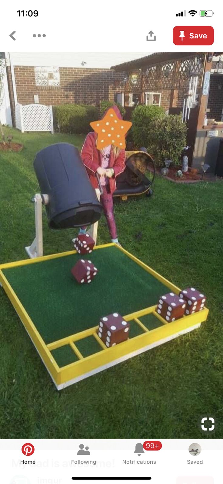 a person in a red jacket and some dices on a green lawn with a yellow frame