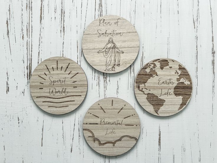 three wooden coasters with different designs and words on them, sitting on a white surface