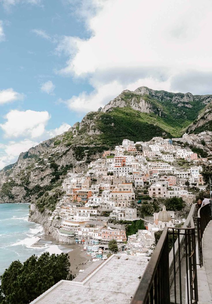 a view of the ocean and mountains from a balcony in positi, italy