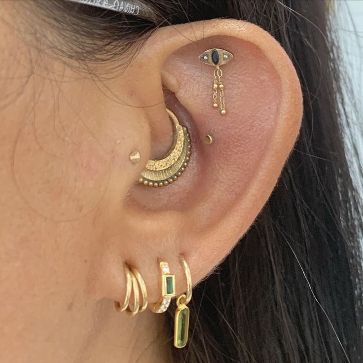 a close up of a person's ear with two different types of piercings