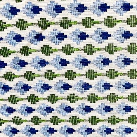 a blue and green pattern on white fabric