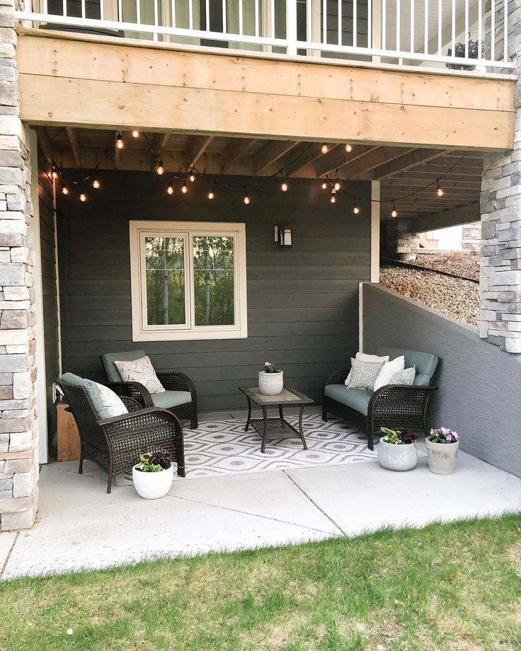 an outdoor patio with chairs and lights