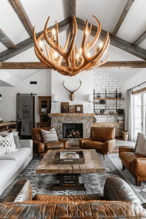 a living room filled with furniture and a large deer antlers hanging from the ceiling