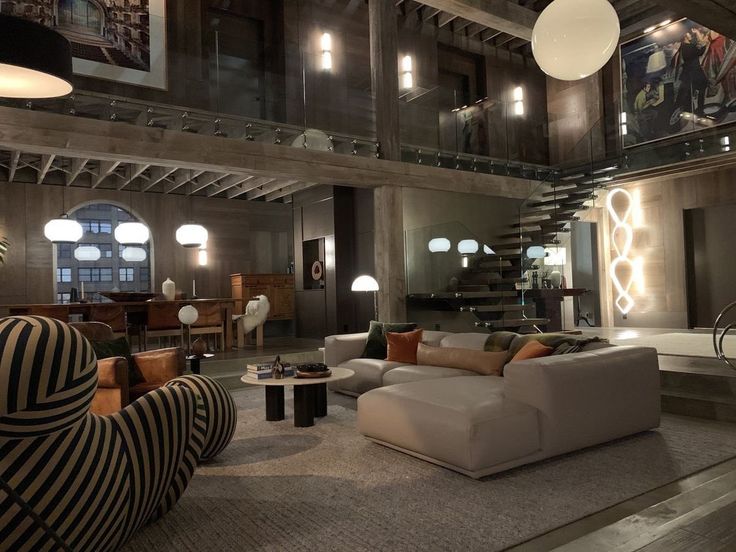 a living room filled with lots of furniture next to a fire place in a building