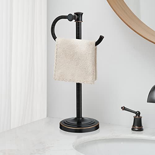 a bathroom sink with a towel holder on the counter and a mirror in the background