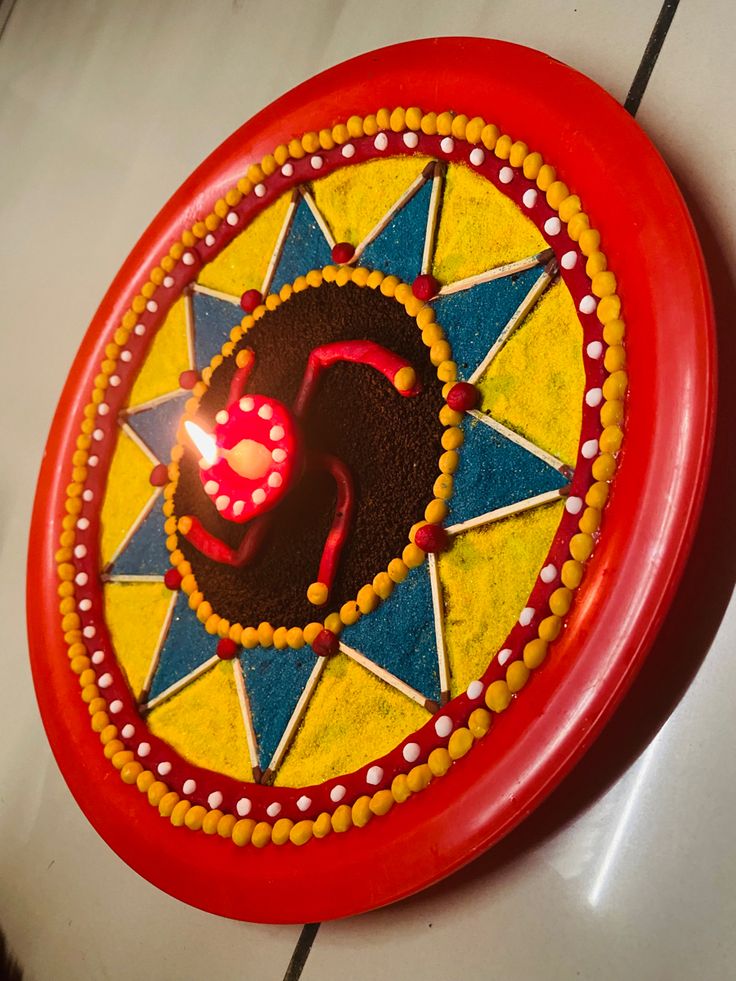 a red plate topped with a cake covered in icing