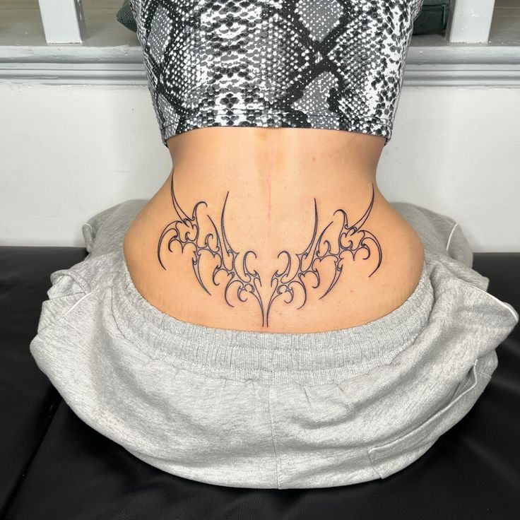 a woman with a tattoo on her lower back