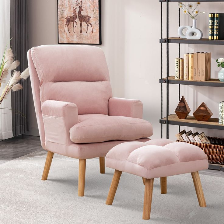 a pink chair and footstool in a living room