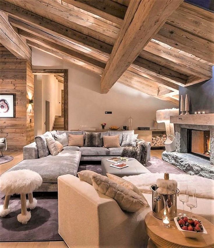 a living room filled with furniture and a fire place in the middle of a room