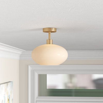 a light that is on the ceiling above a window in a room with white walls