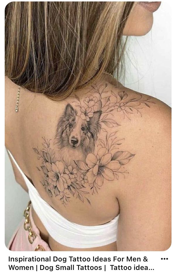 the back of a woman's shoulder with a dog and flowers tattoo on it