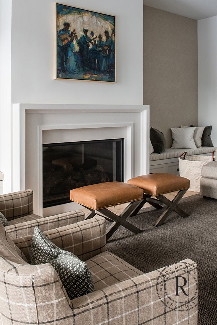 a living room filled with furniture and a fire place in front of a painting on the wall