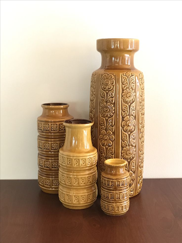 three vases sitting on top of a wooden table