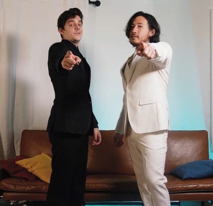 two people in suits pointing at something