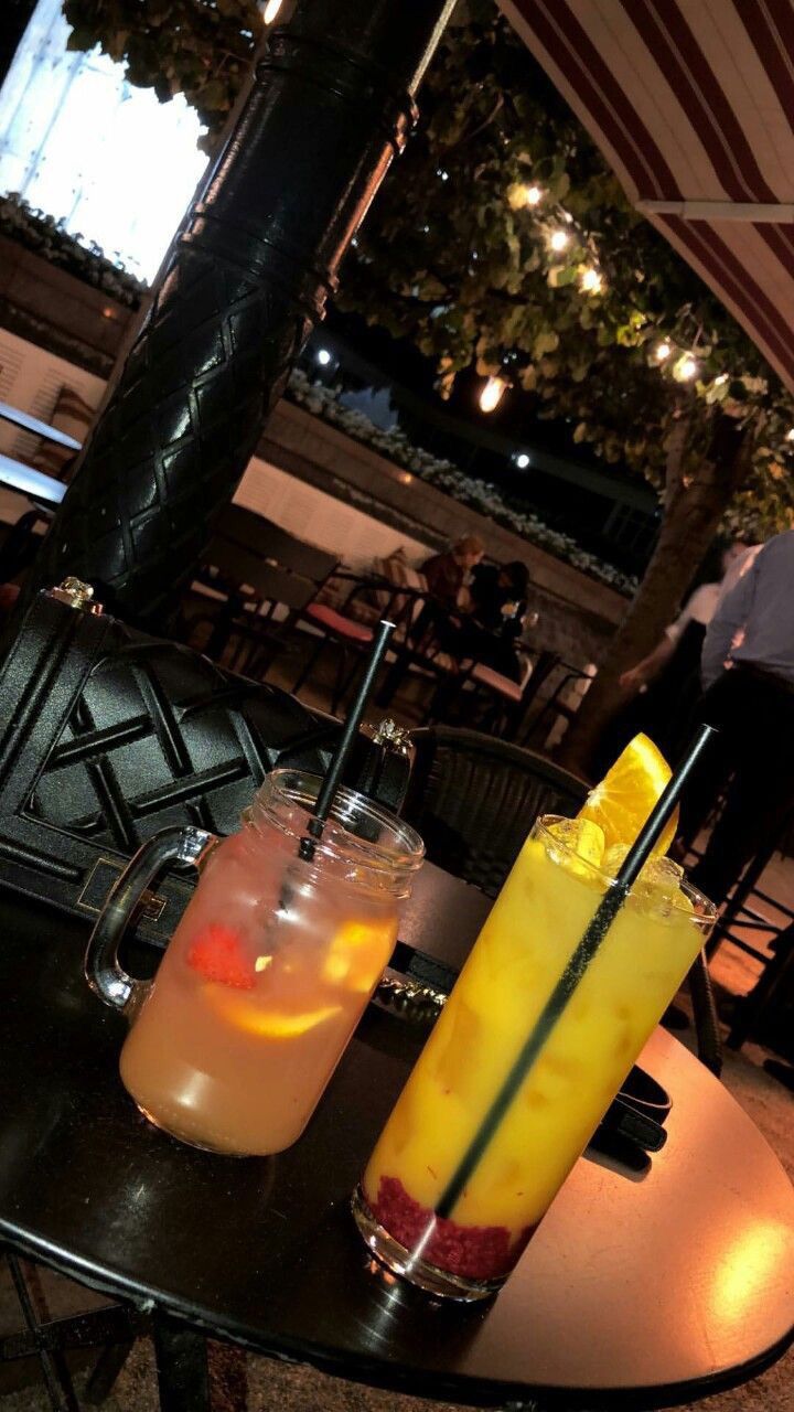 two drinks sitting on top of a table next to each other