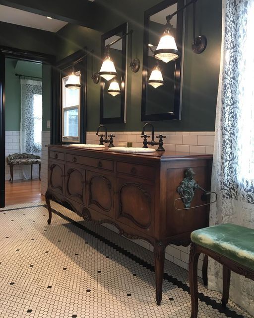 an old fashioned bathroom with two sinks and three mirrors on the wall next to a bench