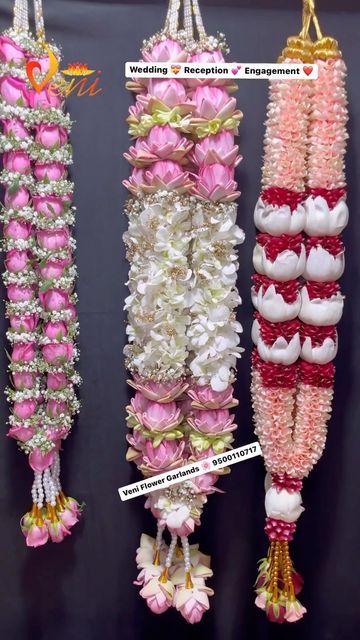 three rows of pink and white flowers hanging from strings