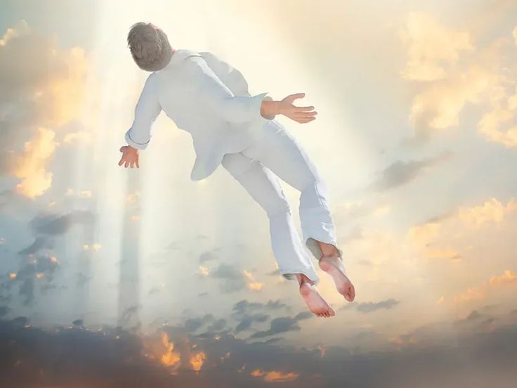 a man in white suit flying through the air