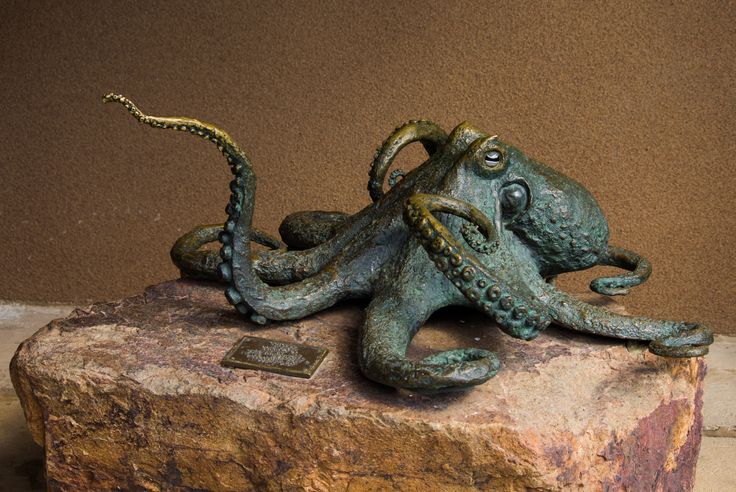 an octopus sculpture sitting on top of a rock